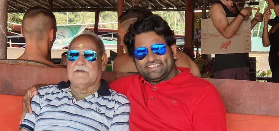 Dr. D.P. Shukla with an older man in sunglasses at an open-air café