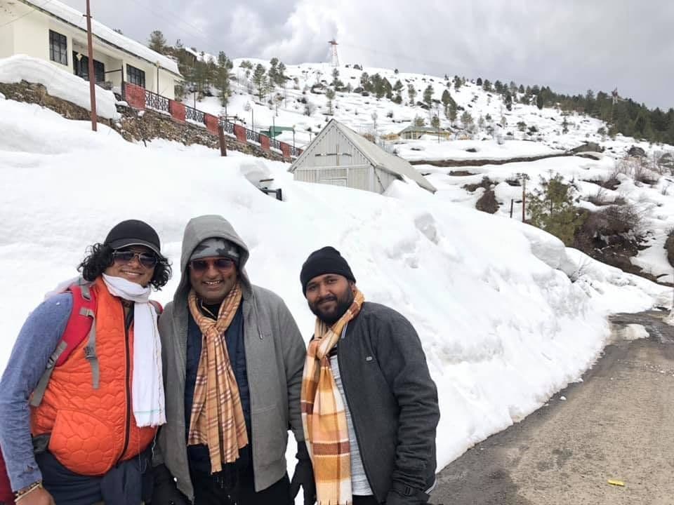 Dr. D.P. Shukla with two friends in scarves on a snowy hillside