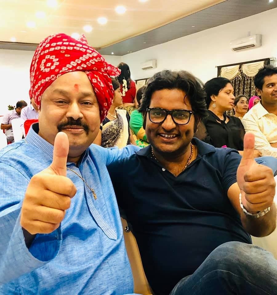 Dr. D.P. Shukla with a man in a red turban, both giving a thumbs up