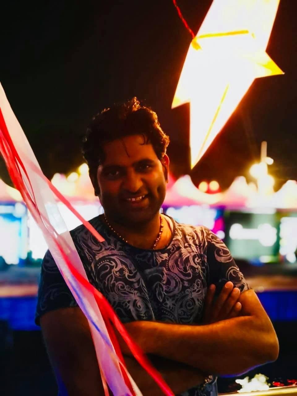 Dr. D.P. Shukla at night under a lit festival decoration
