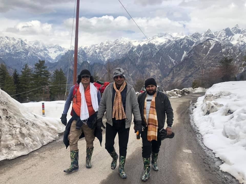 Dr. D.P. Shukla and two friends walking along a snowy mountain road