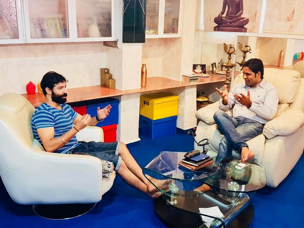 Dr. D.P. Shukla in conversation with a visitor in the consultation room