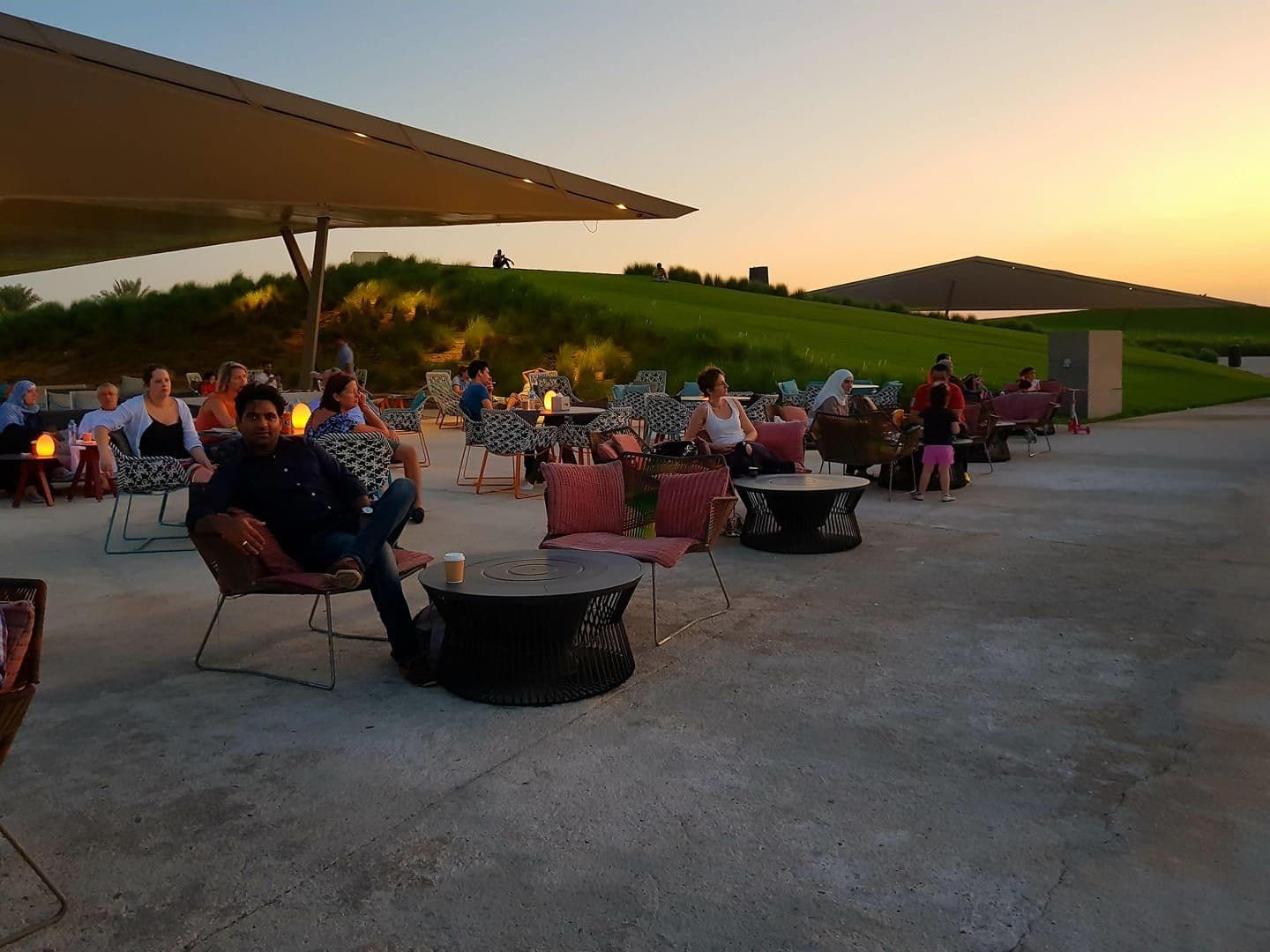 Guests on an open-air terrace at sunset