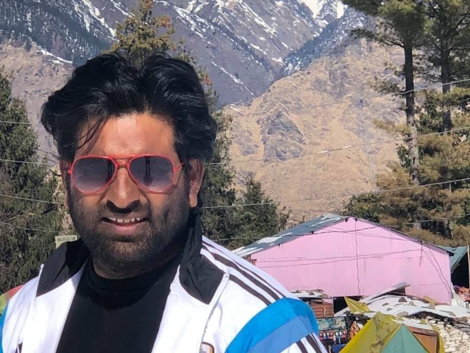 Dr. D.P. Shukla in sunglasses at a mountain campsite