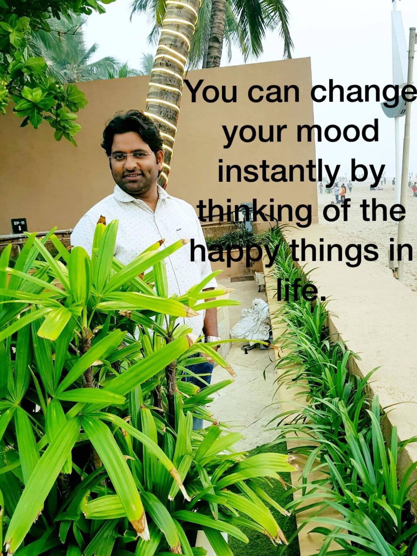 Quote card with Dr. D.P. Shukla among plants: “You can change your mood instantly by thinking of the happy things in life.”