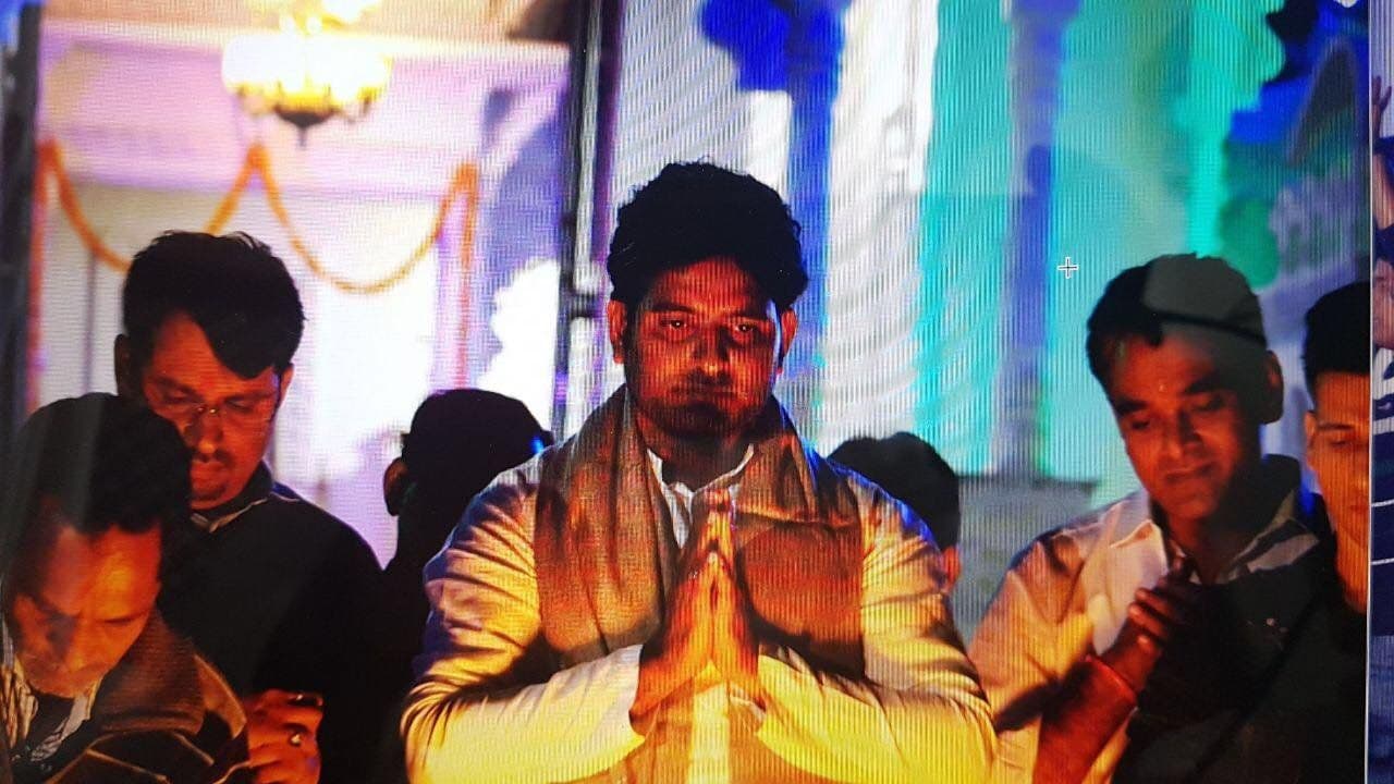 Dr. D.P. Shukla with folded hands among friends at an evening celebration