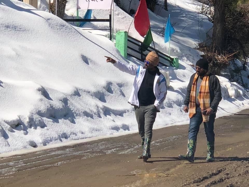 Dr. D.P. Shukla and a friend walking on a snowy road