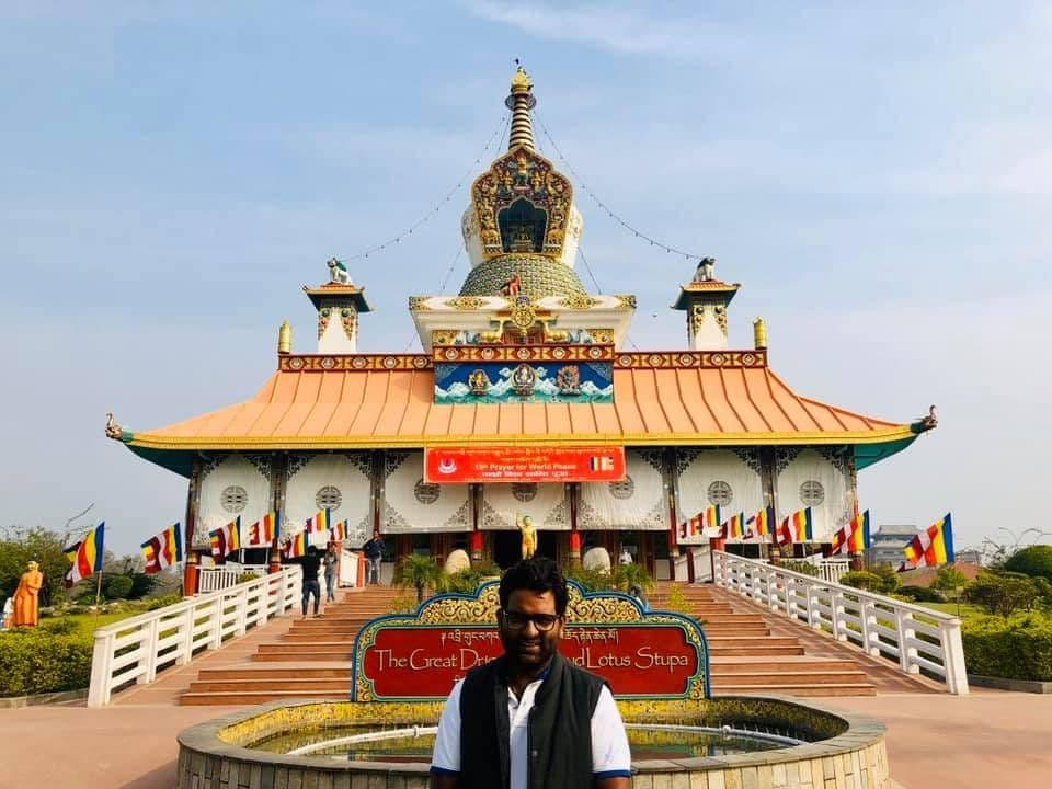 Dr. D.P. Shukla in front of a Buddhist stupa