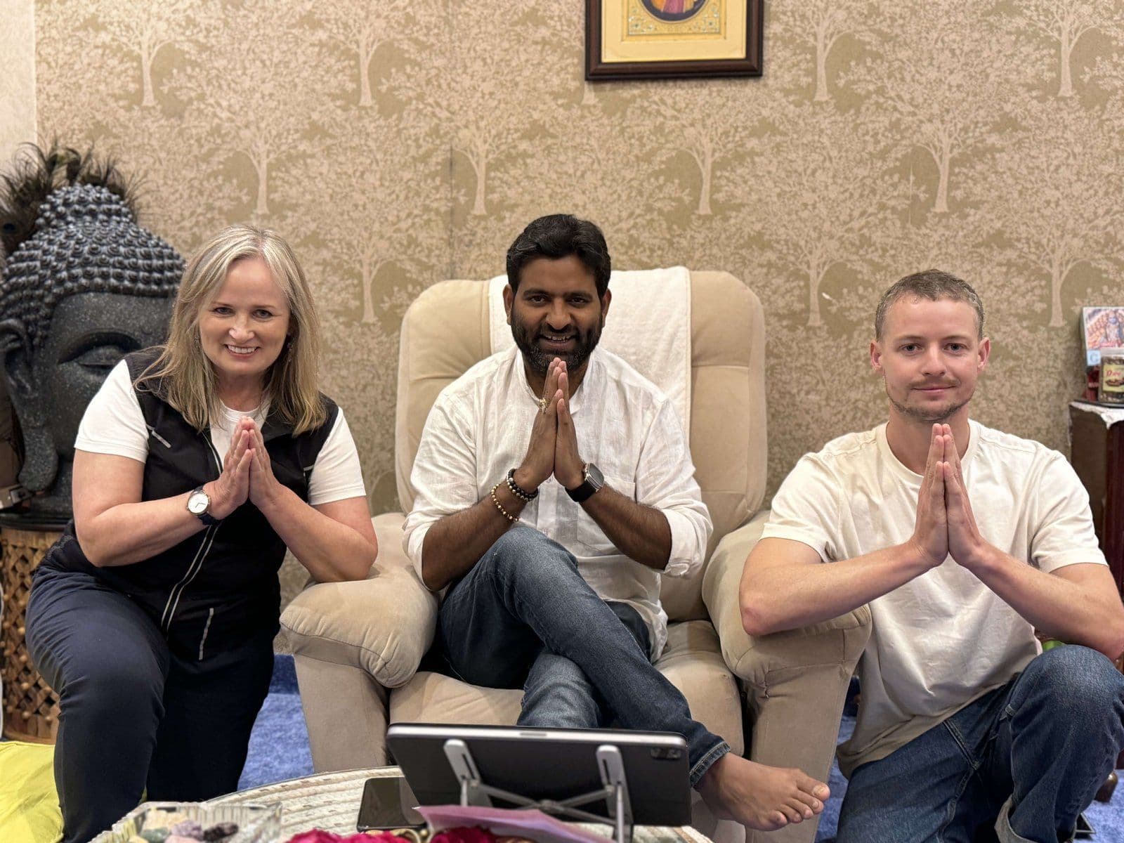 Dr. D.P. Shukla seated between two visitors, all with folded hands