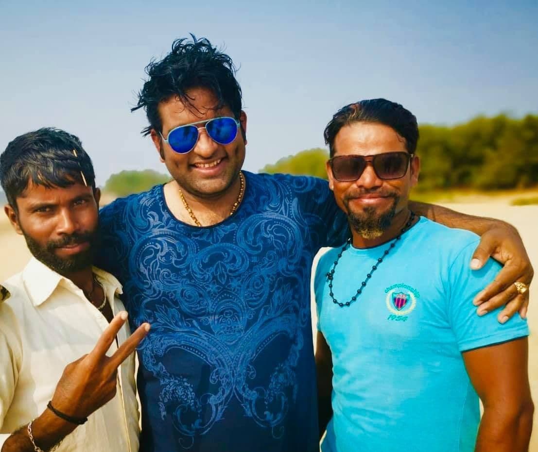 Dr. D.P. Shukla with two friends on a sunny beach