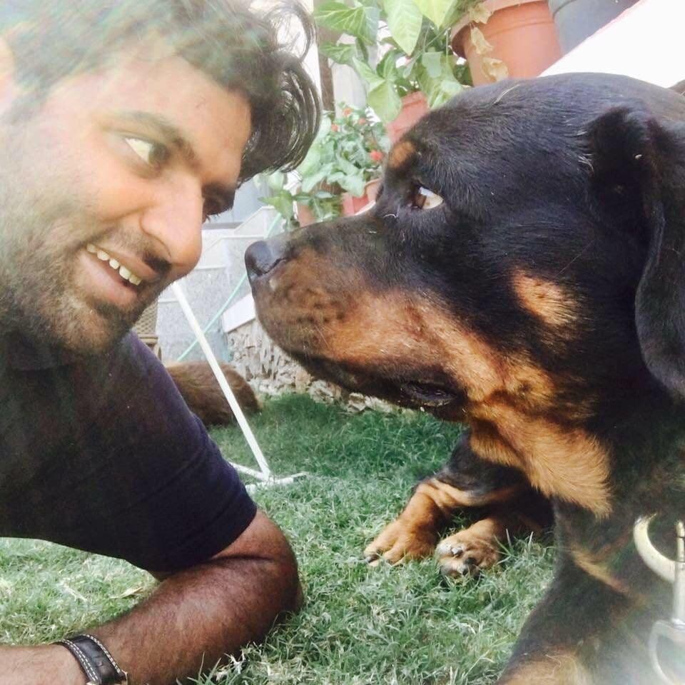 Dr. D.P. Shukla face to face with his rottweiler on the lawn