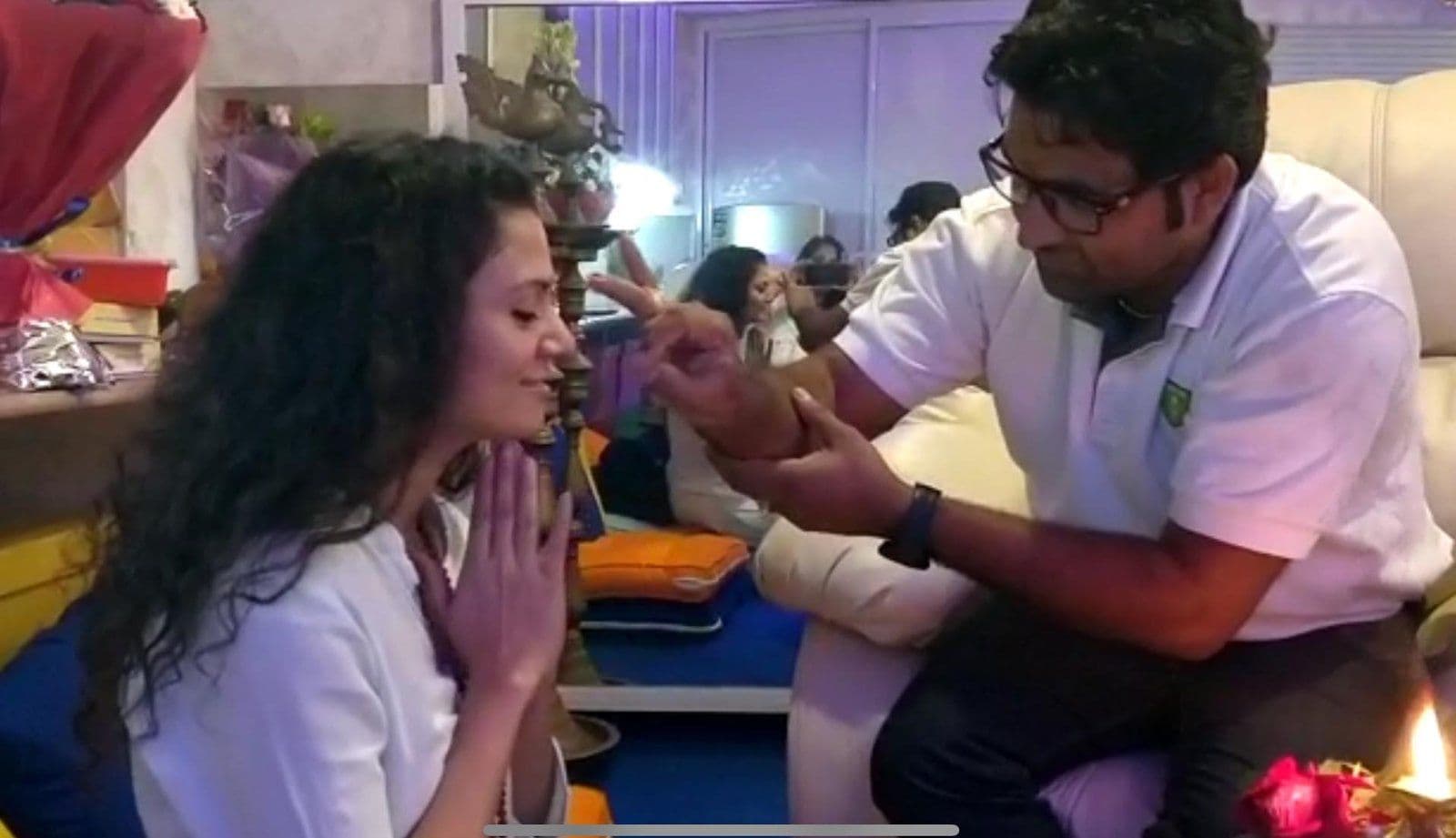 Dr. D.P. Shukla blessing a woman who sits with folded hands