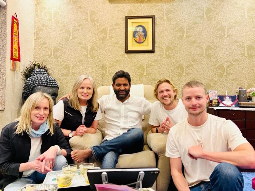 Dr. D.P. Shukla with a group of five visitors in the consultation room