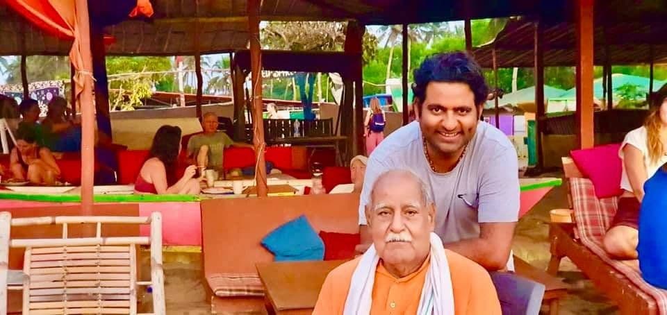 Dr. D.P. Shukla with an elderly sadhu at an open-air café